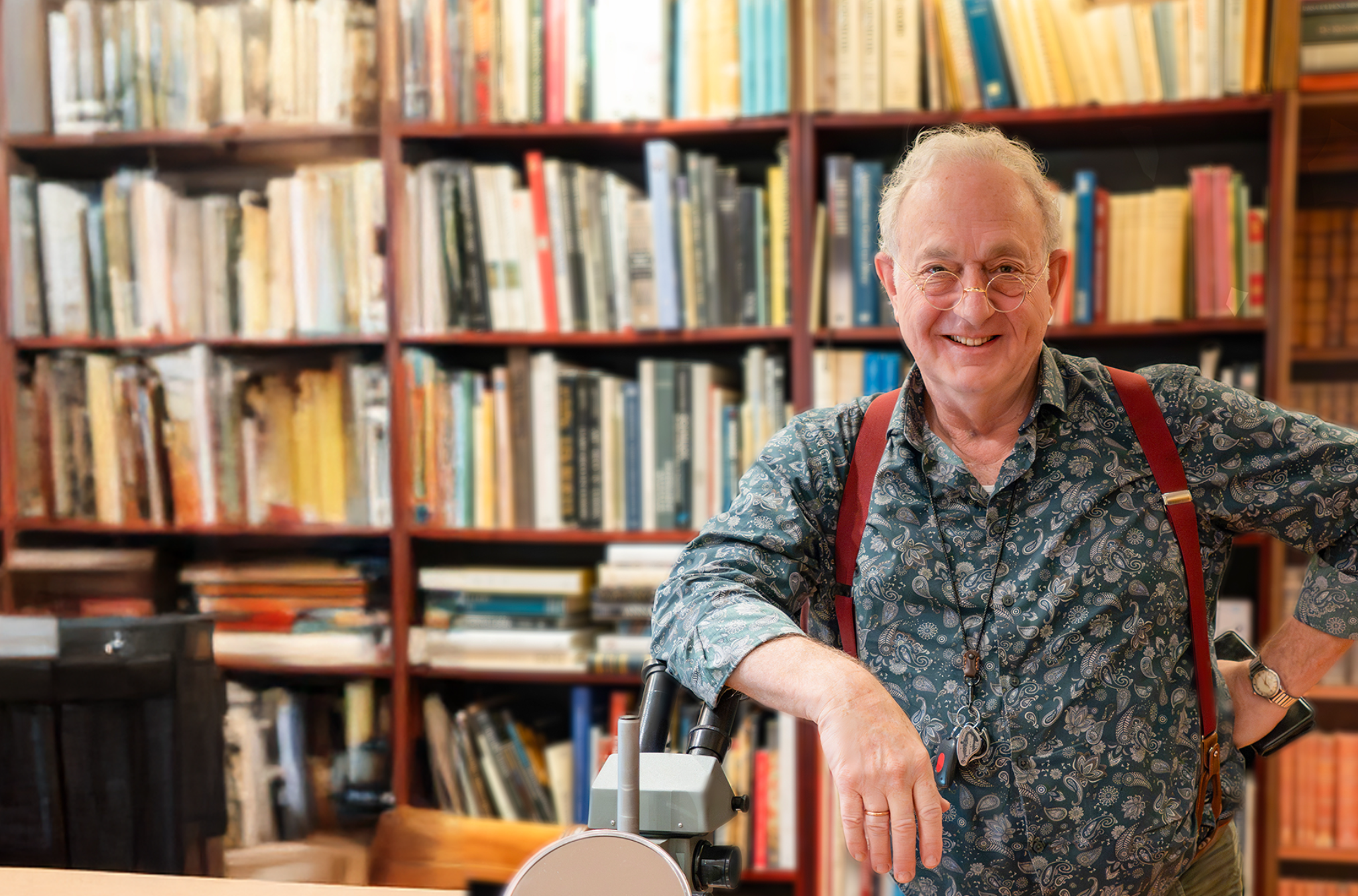 Juwelenexpert bij Adin, met boeken en een microscoop